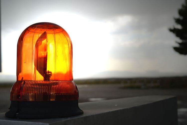Closeup shot of an illuminated orange warning caution light